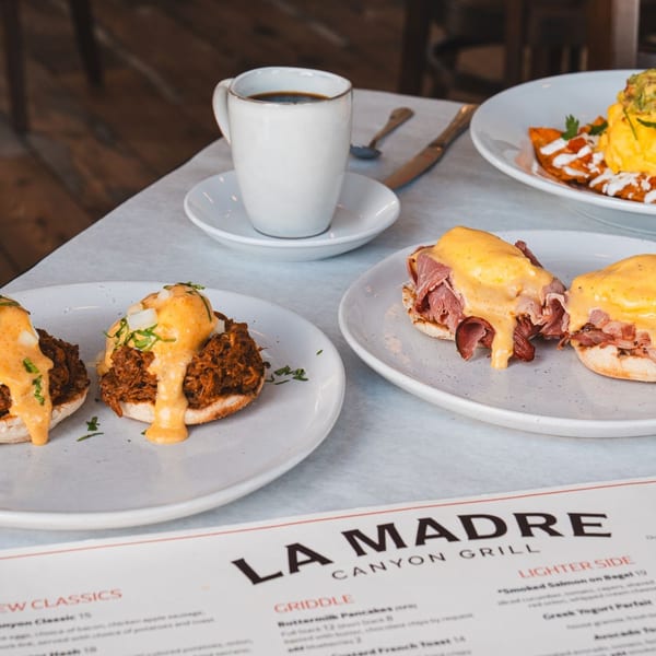 Three breakfast plates from La Madre Canyon Grill, including two types of Eggs Benedict and chilaquiles.