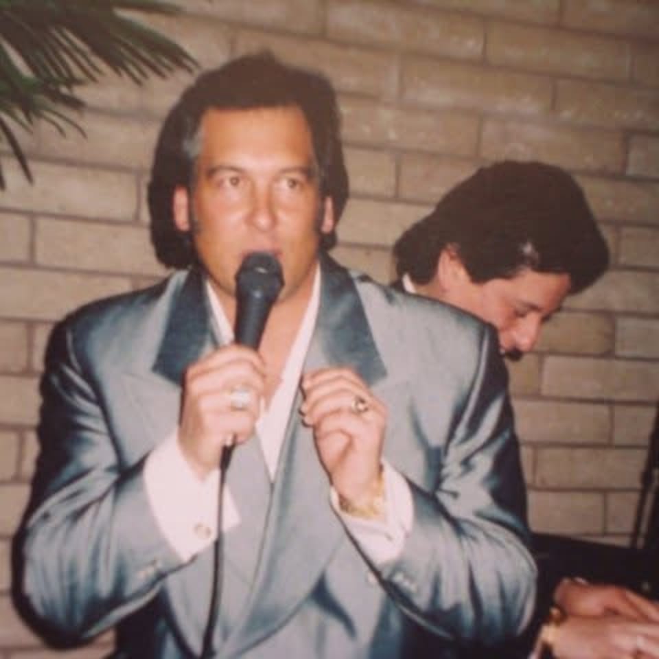 Craig singing into a microphone