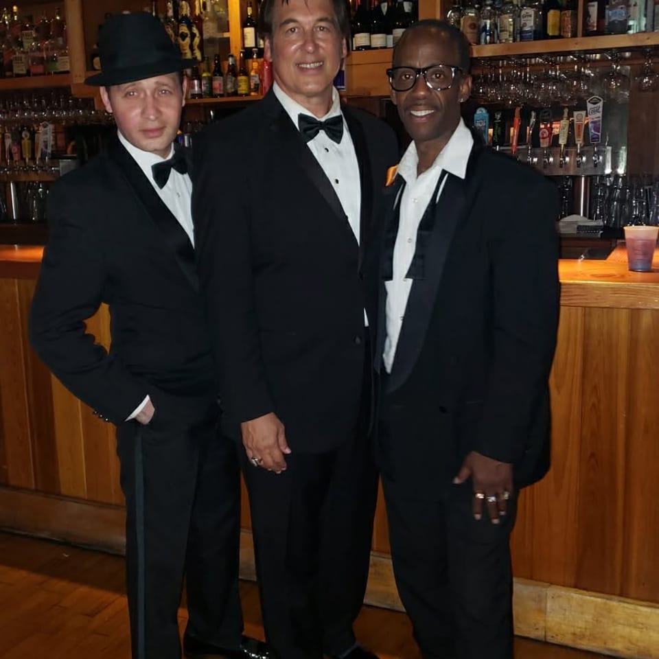 Craig with two companions at a bar